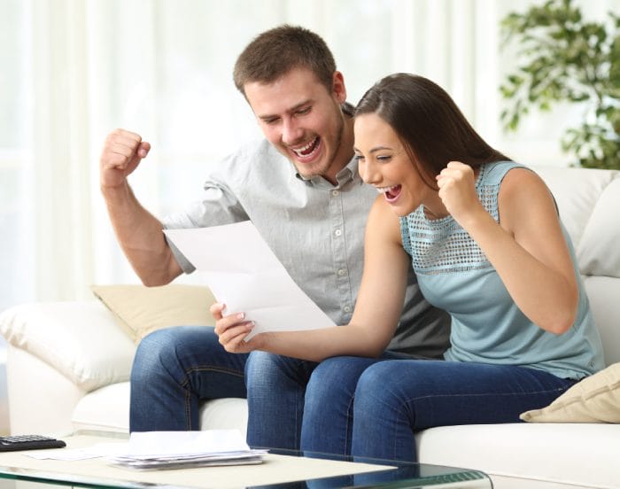Excited couple reading letter